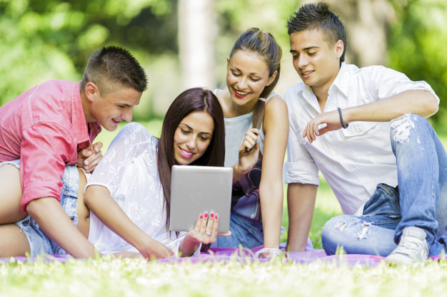 Teenagers in the park with tablet
